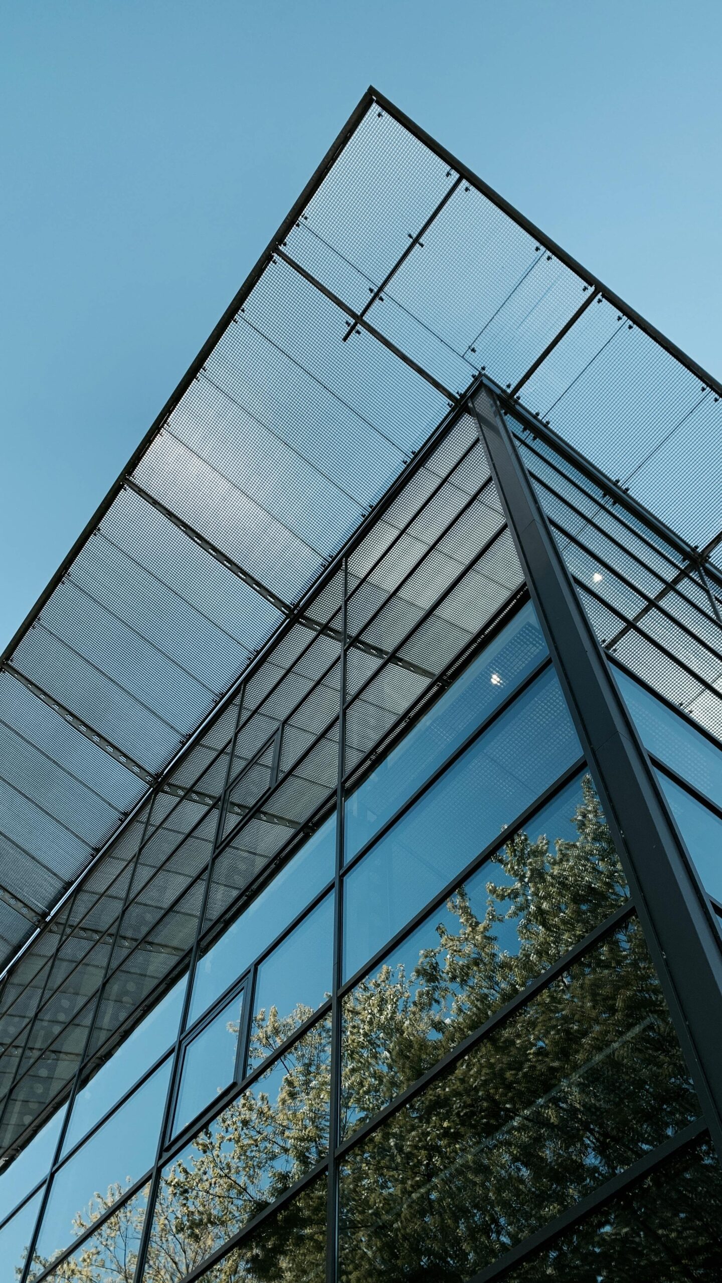 Low-angle view of a modern glass building in Duivendrecht, Netherlands.